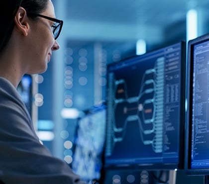 woman looking at computer screen at company that uses it managed services