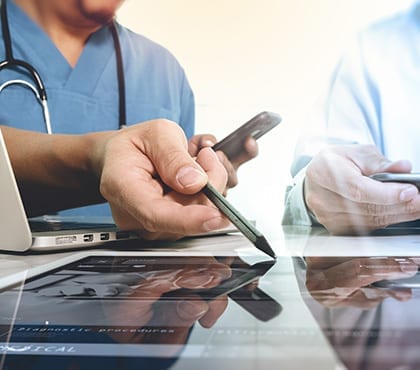 doctor speaking to patient using tablet that is protected by data security