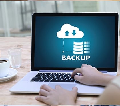 it consultant running a computer backup on a laptop