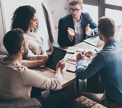 people sitting around table discussing digital security options for company