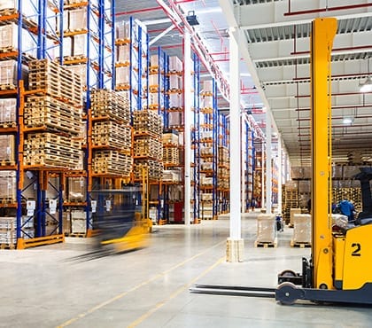 warehouse with shelves filled with pallets for company that uses managed services