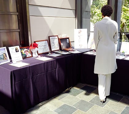 woman at silent auction event for company that uses information security