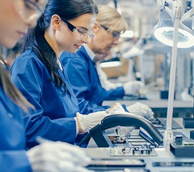 workers putting together circuit boards for company that uses computer security